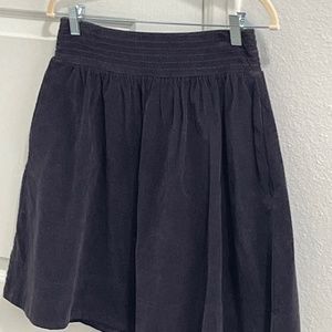 Navy corduroy pleated skirt with pockets.